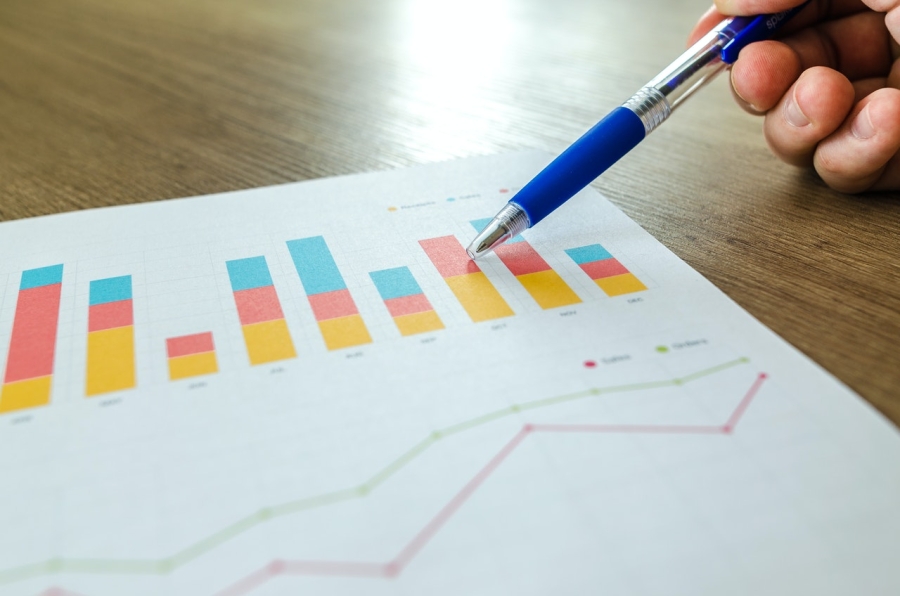 a pen pointing at a colourful data diagram