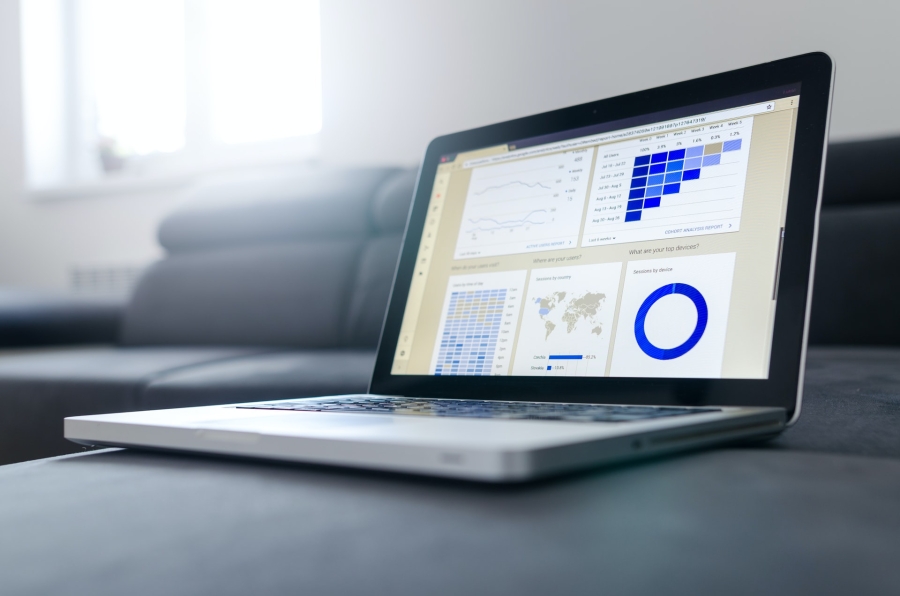 an open laptop sitting on a table showing digital reports and diagrams