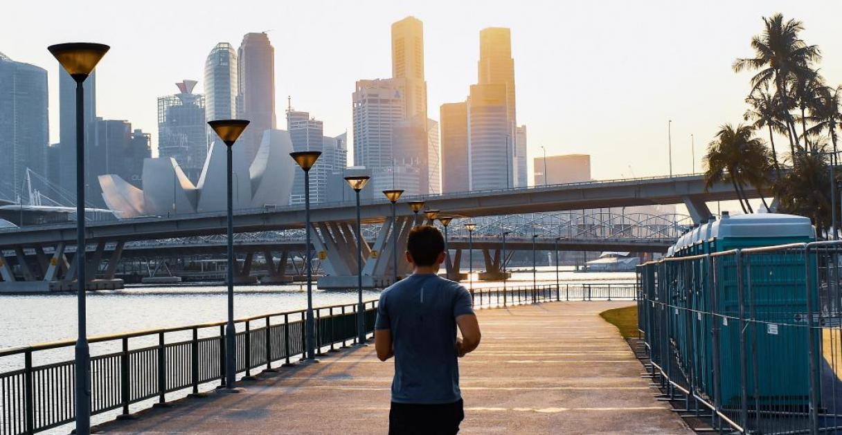 man jogging with skyscrapers in the background
